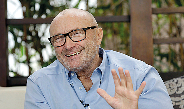 FILE - In this Dec. 4, 2013 file photo, British musician Phil Collins, smiles during an interview in Miami Beach, Fla. State lawmakers have named pop star Phil Collins an honorary Texan, saluting his donation of hundreds of Alamo artifacts back to the historic outpost. The former Genesis singer-drummer appeared Wednesday, March 11, 2015, in the Texas Legislature. He didn't give a speech, but greeted lawmakers who crowded to shake hands. (AP Photo/Alan Diaz, File)